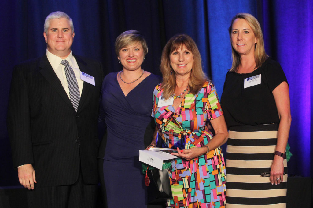 Employee of the Year Linda Hastings (third from left) with Plaza Medical Center of Fort Worth CEO Clay Franklin (left).